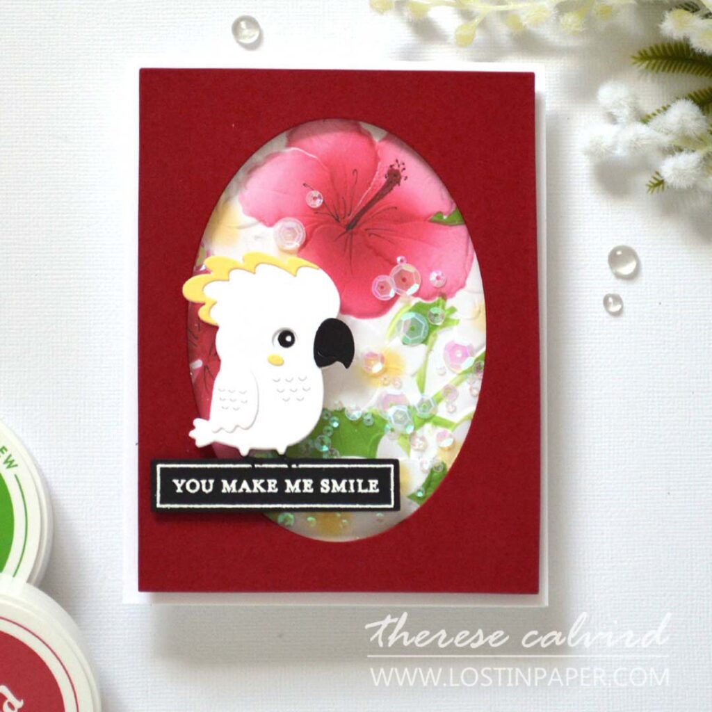 A2 shaker card with embossed ink-blended floral background and a die-cut bird sitting on the sentiment.