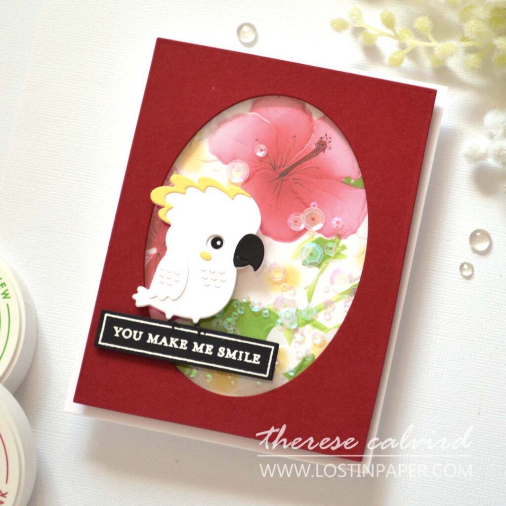 A2 shaker card with embossed ink-blended floral background and a die-cut bird sitting on the sentiment.