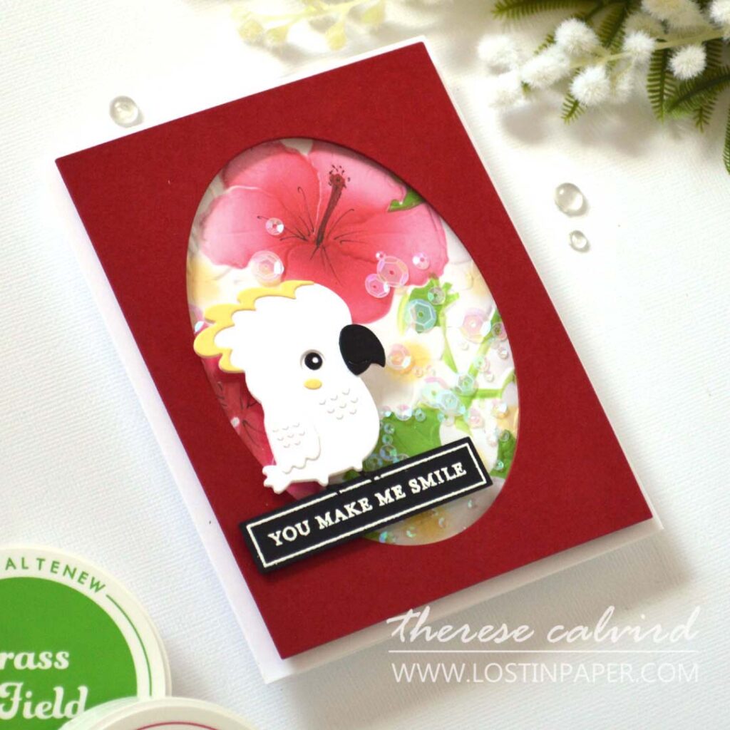 A2 shaker card with embossed ink-blended floral background and a die-cut bird sitting on the sentiment.
