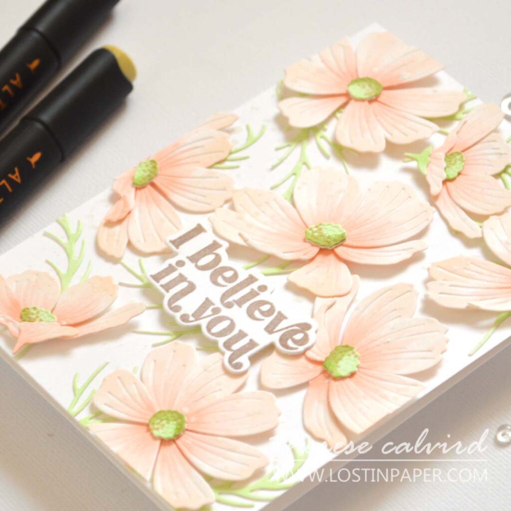 Handmade card with a sea of layered Cosmos flowers covering the entire background