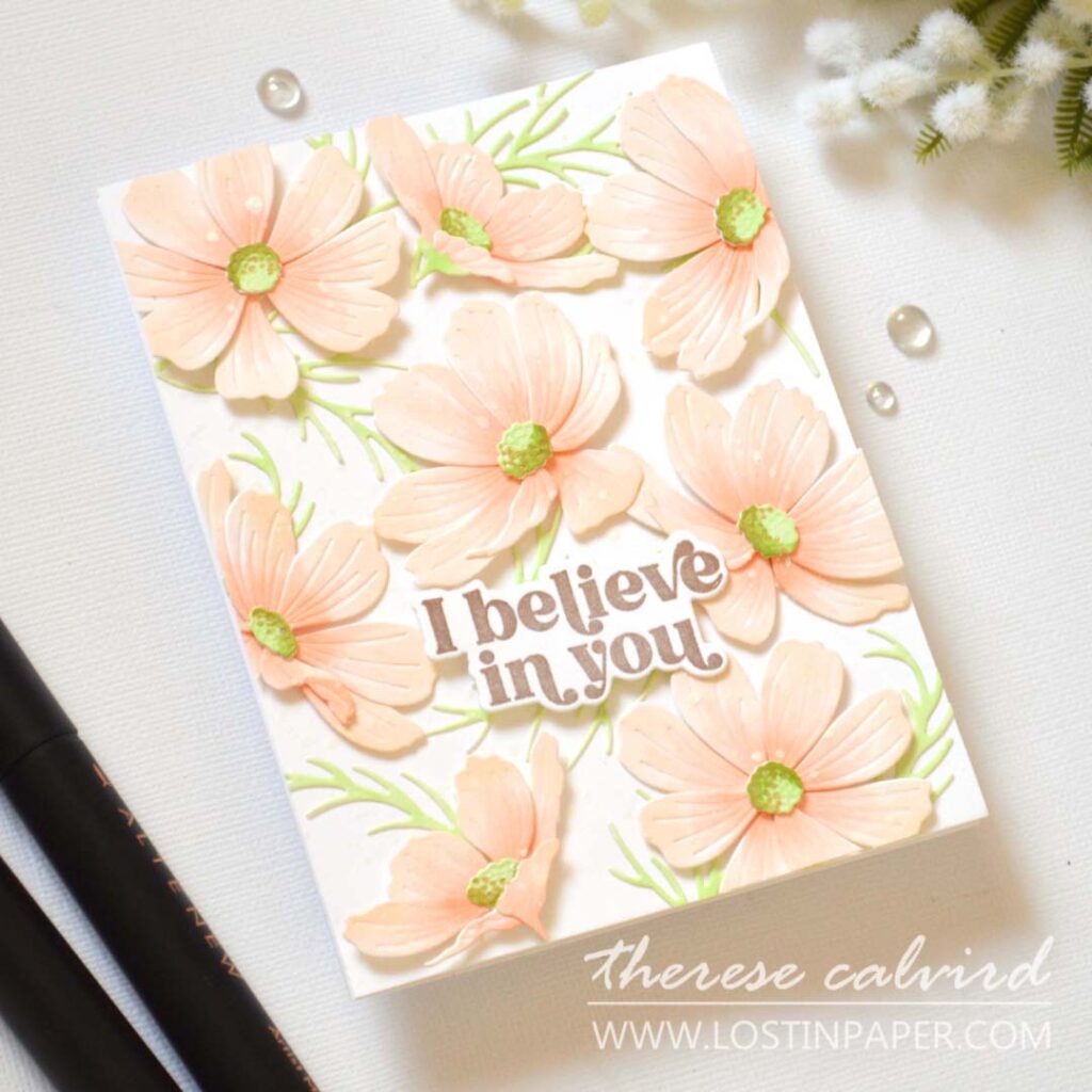 Handmade card with a sea of layered Cosmos flowers covering the entire background