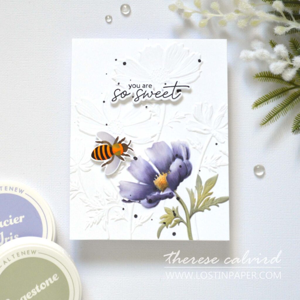 Focal point card with 3D embossed background, one flower colored using a stencil, a small bee accent, and optional coloring with markers, pencils, or paints