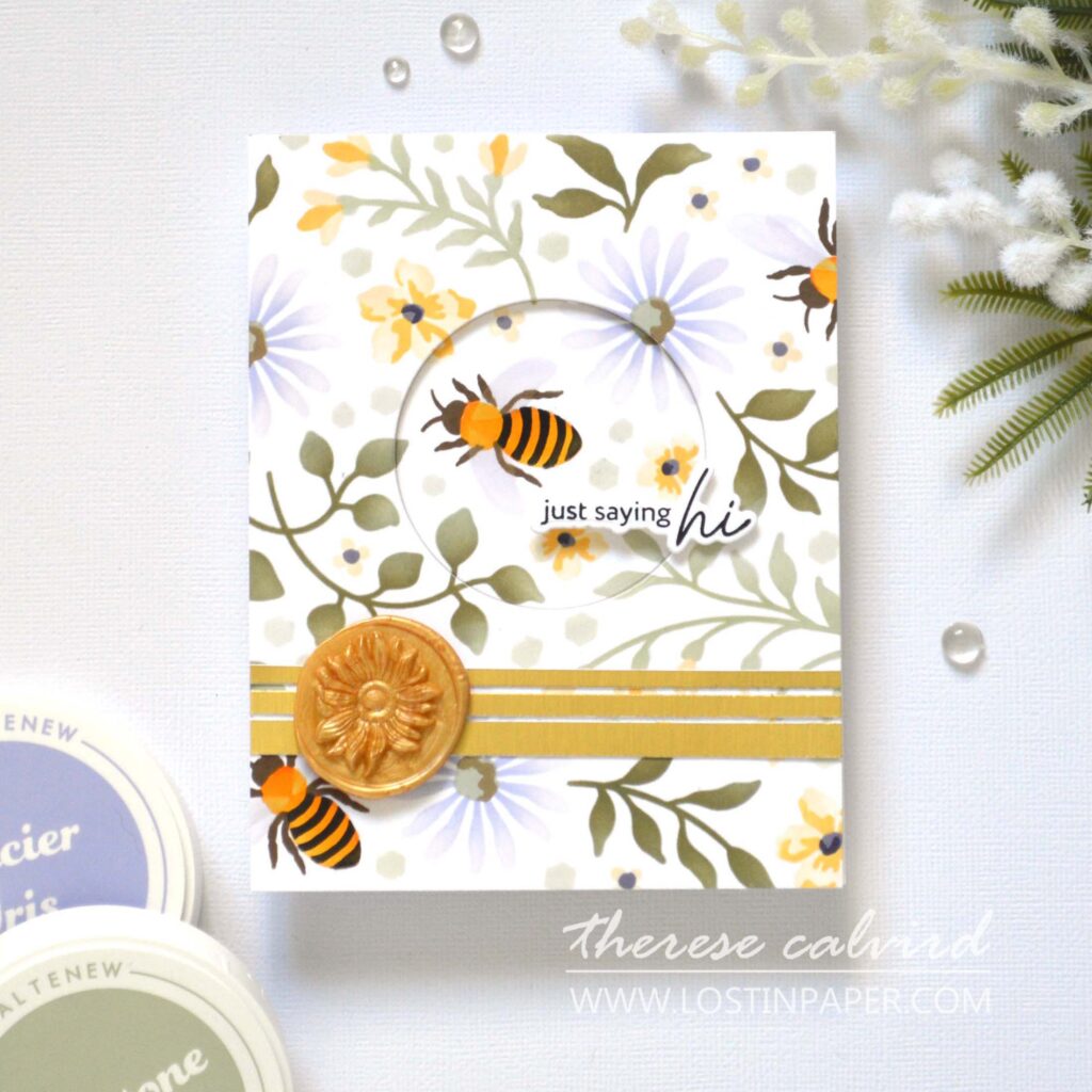 Focal point card with floral stencil background, recessed circular window with bee and sentiment, accented with a small floral wax seal