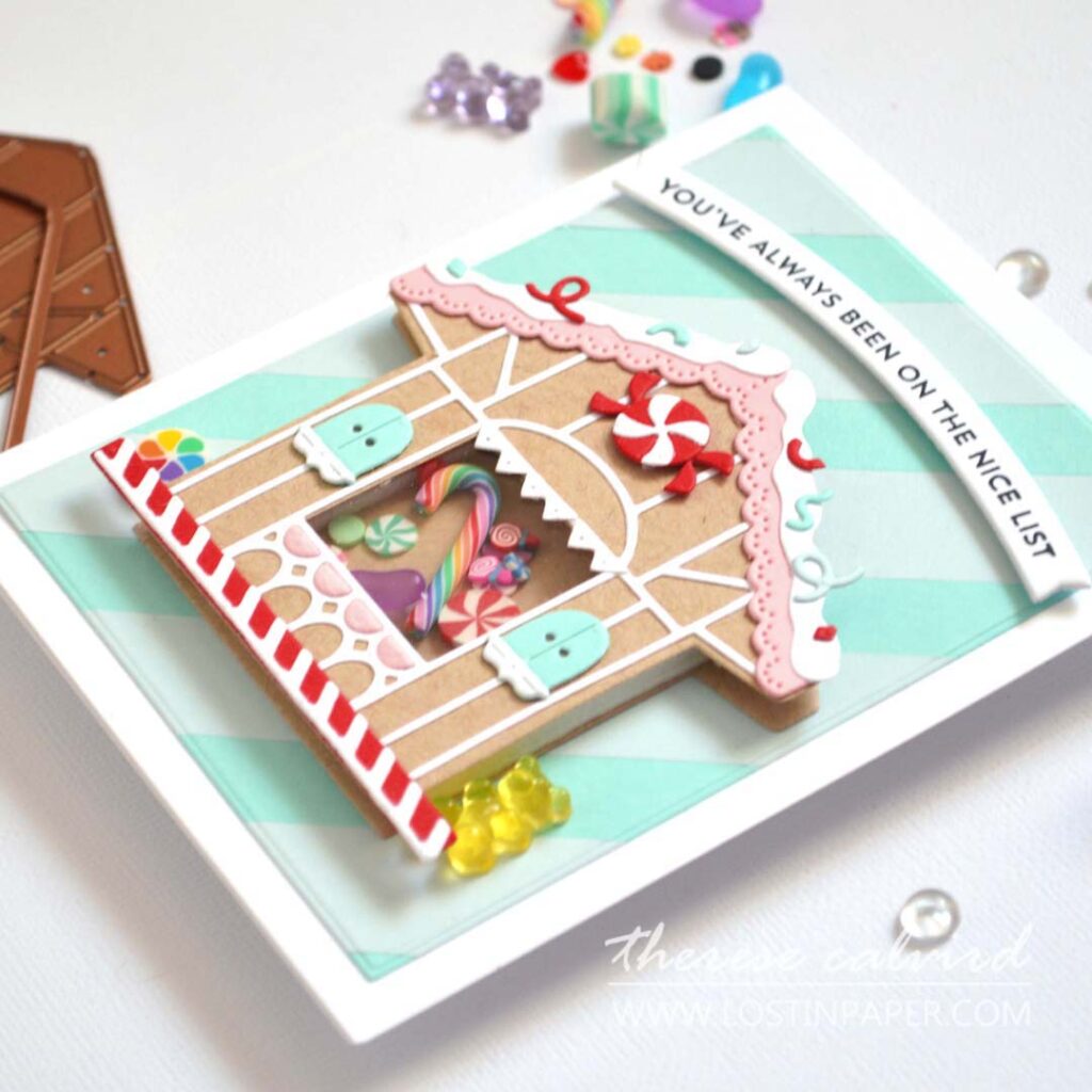 Gingerbread house shaker card filled with sweets and a striped background by Therese Calvird