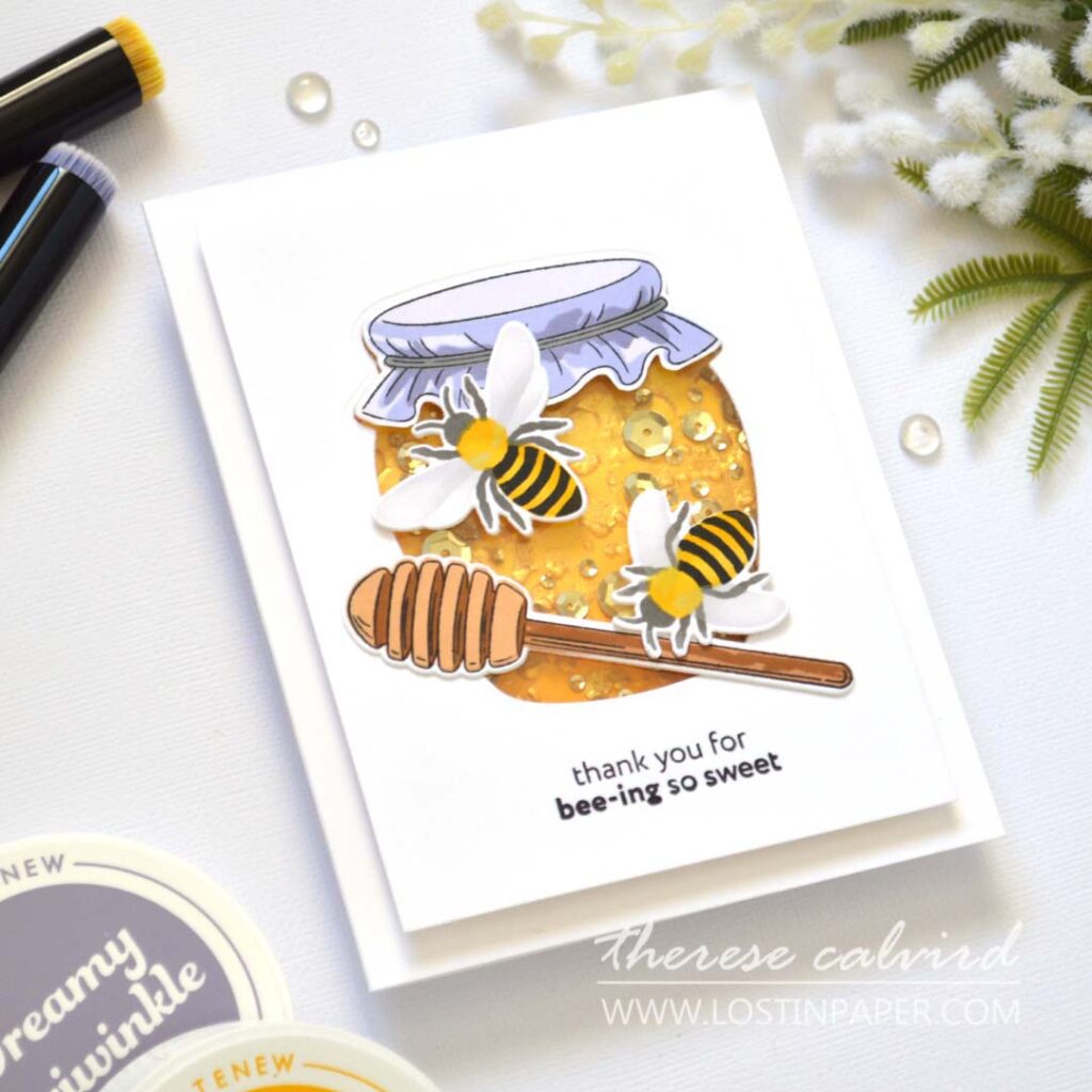 Shaker card designed as a honey jar, with embossed honeycomb background, gold highlights, and sparkling golden sequins.