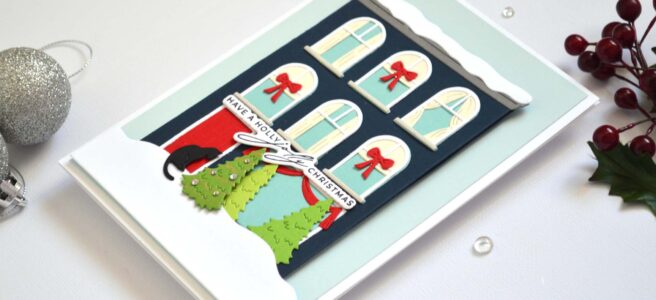 Jolly Christmas house card featuring a die-cut city building with a black cat at the front door by Therese Calvird.