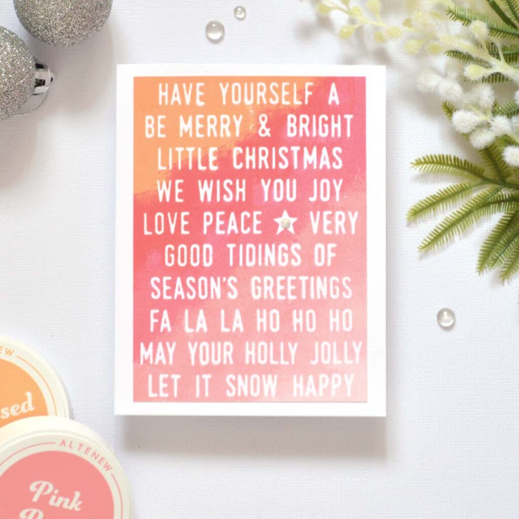 Handmade Christmas card from Therese Calvird’s Same But Different Christmas series with a multi-sentiment background ombre-stamped in red and pink tones.