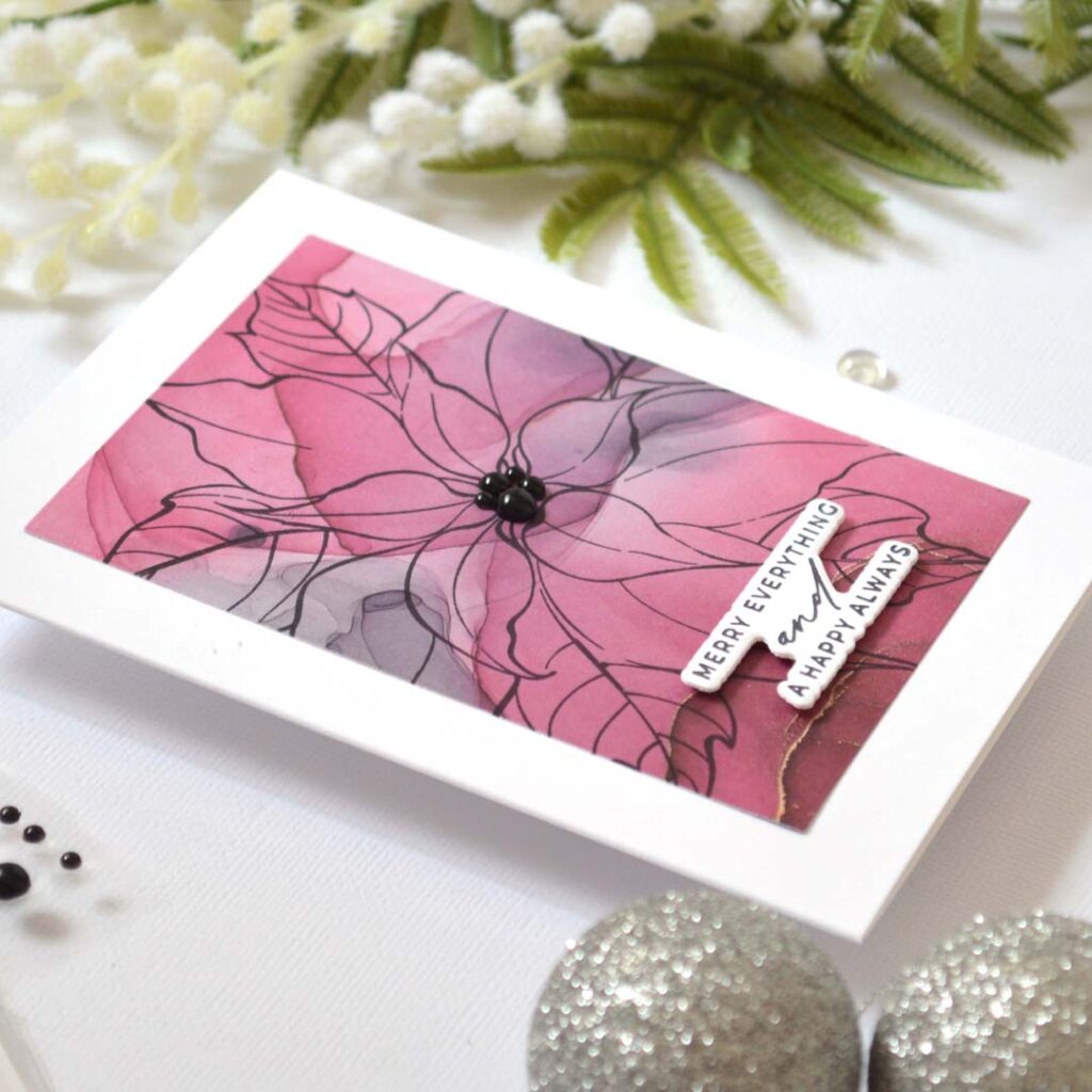 Handmade holiday card from the Same But Different Christmas series by Therese Calvird featuring a large black outline poinsettia stamped on patterned paper with pearl details.