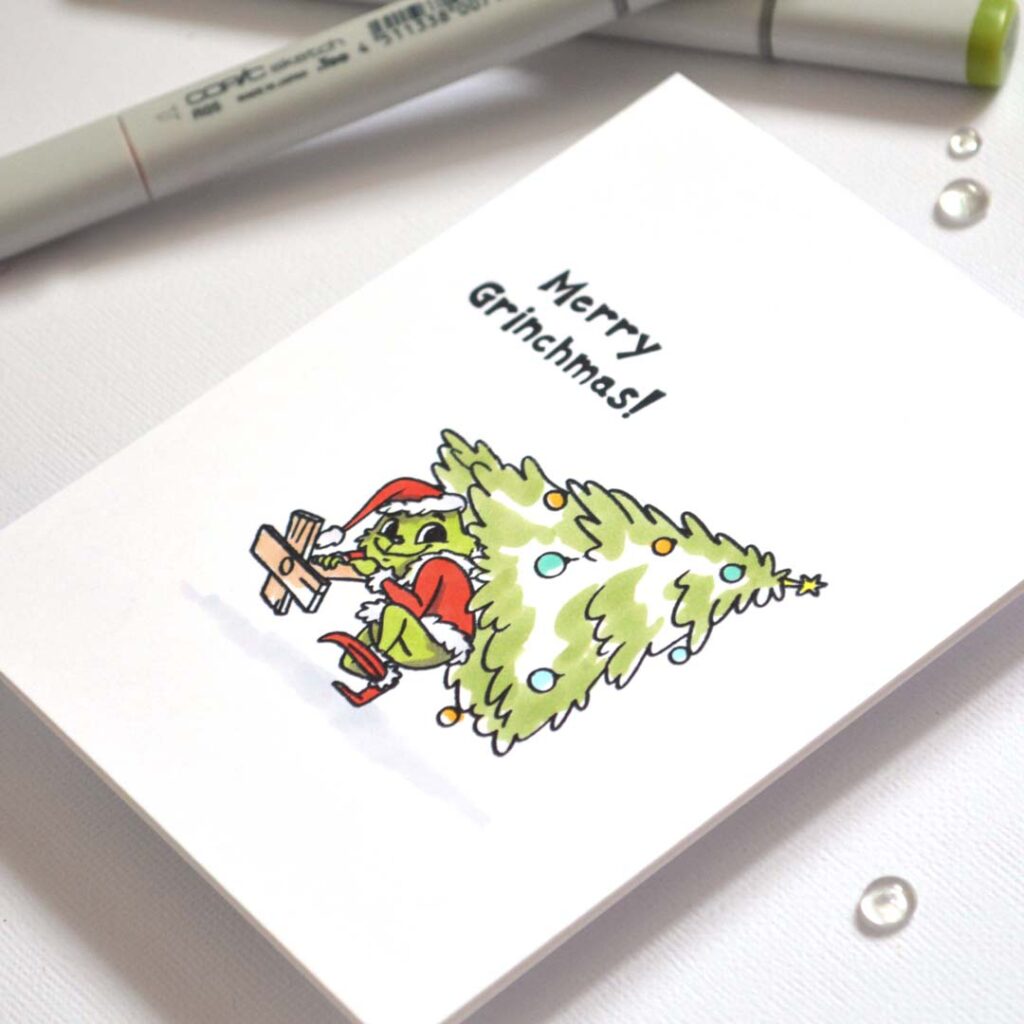 Playful handmade card from Therese Calvird’s Same But Different Christmas series featuring the Grinch running away with a Christmas tree, colored with alcohol markers.