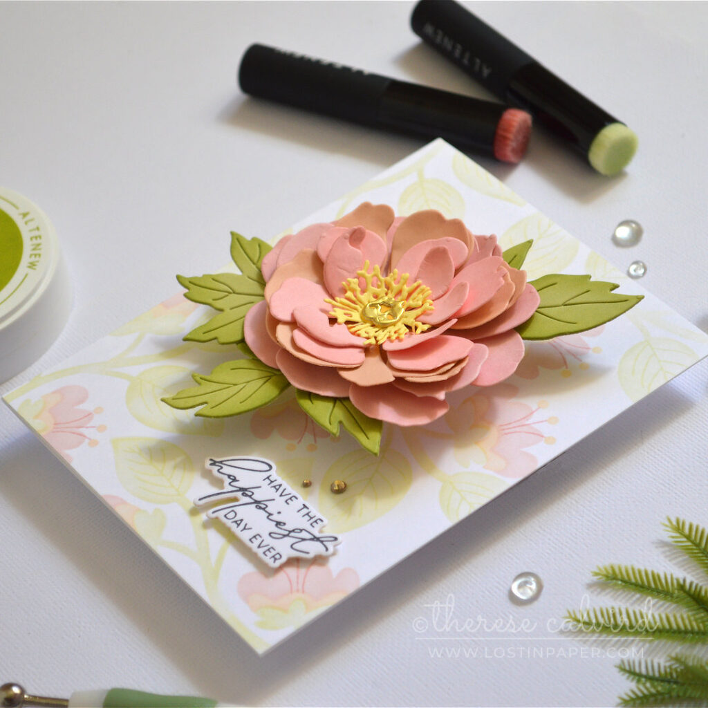 Pink layered flower card featuring a dimensional die cut bloom over a pastel ink blended stencil background