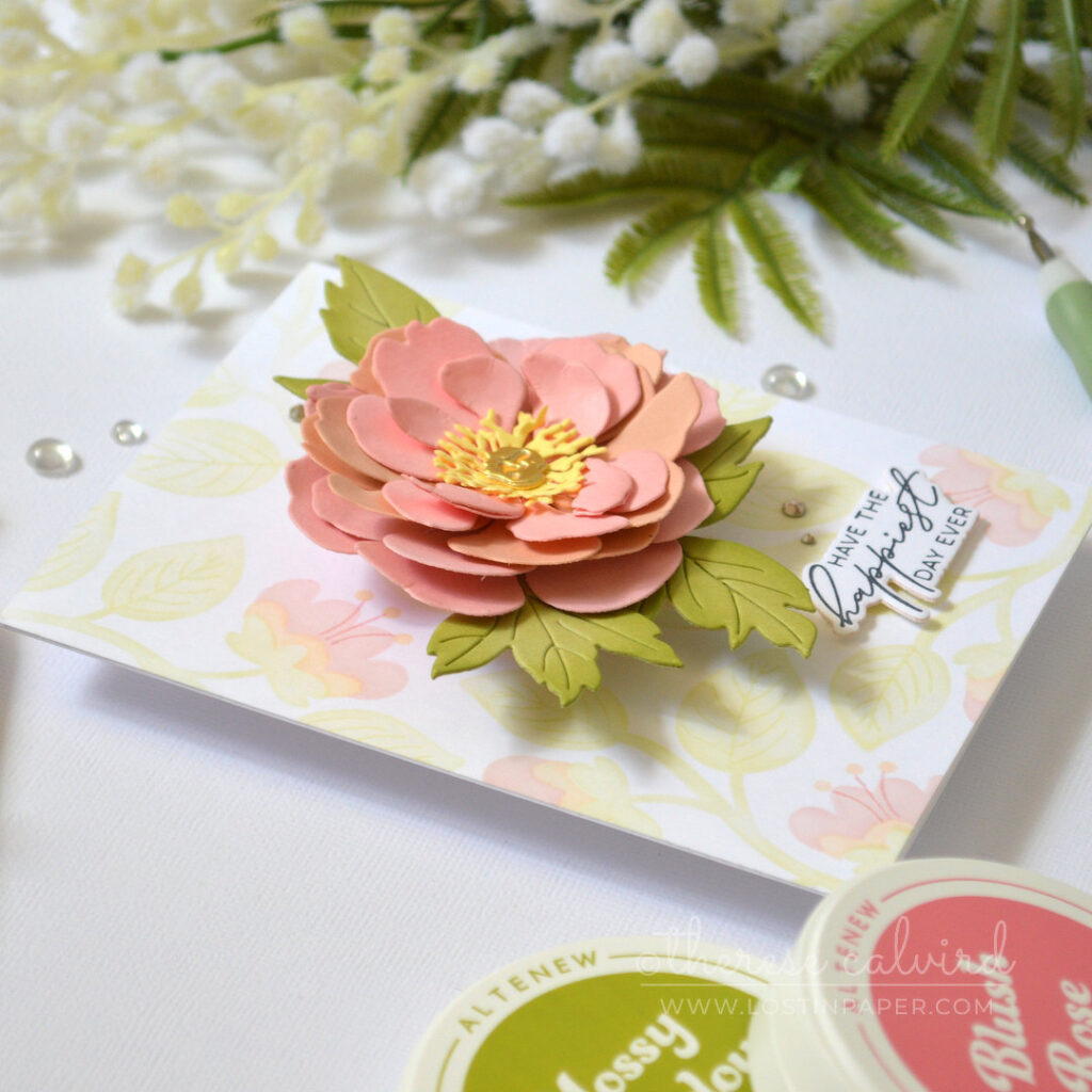 Pink layered flower card featuring a dimensional die cut bloom over a pastel ink blended stencil background