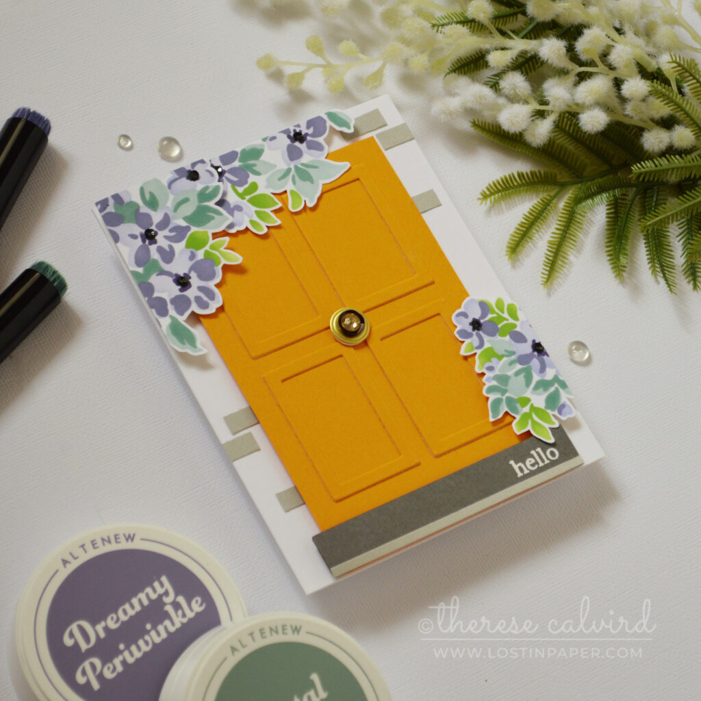 Bright orange door card with small picture frames used as wood panels, decorated with flowers and a rhinestone door knob by Therese Calvird