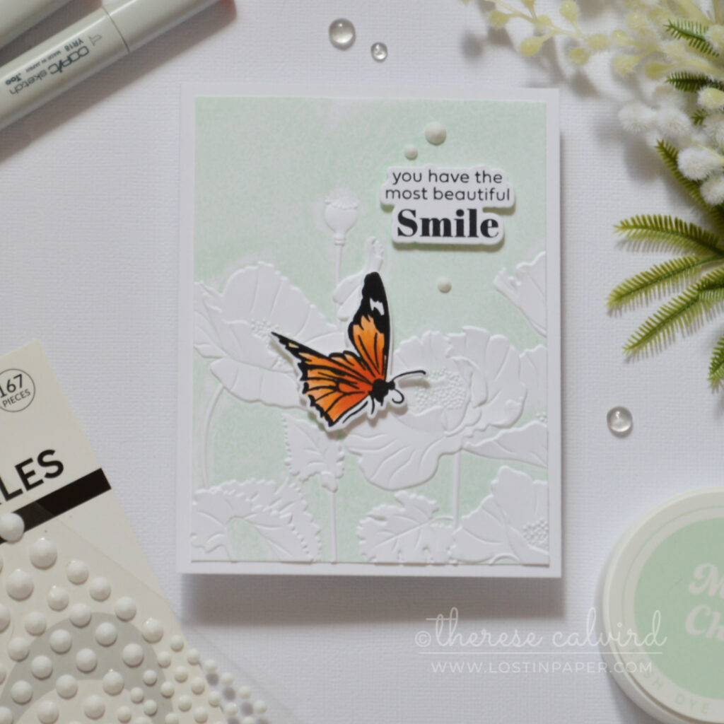 Embossed poppy flowers created by inking an embossing folder, featuring raised pale mint floral details with a clean textured finish.