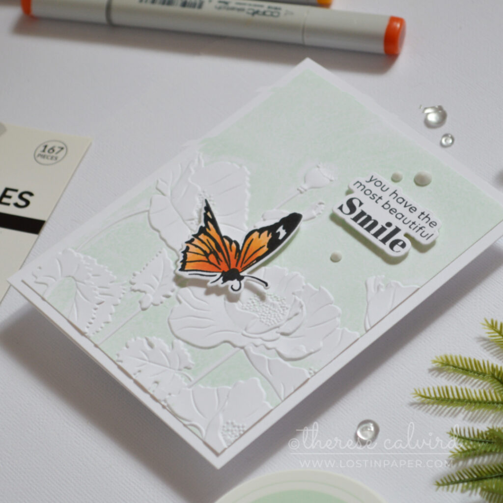 Embossed poppy flowers created by inking an embossing folder, featuring raised pale mint floral details with a clean textured finish.