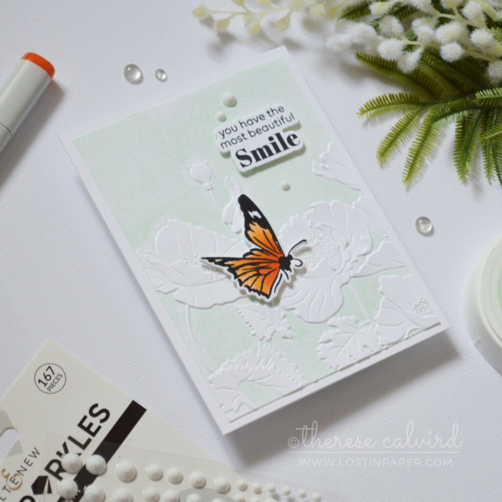 Embossed poppy flowers created by inking an embossing folder, featuring raised pale mint floral details with a clean textured finish.