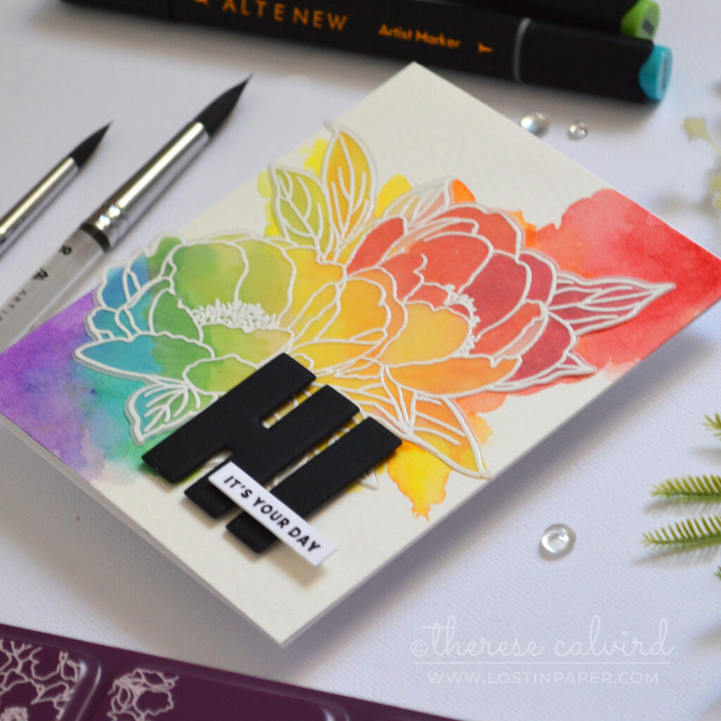 Watercolor rainbow floral card with an embossed vellum bouquet and rainbow coloring on the back of the vellum by Therese Calvird