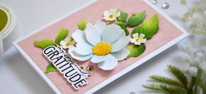 Die embossed trellis background card with ink blended leaves and flowers arranged in a bouquet.