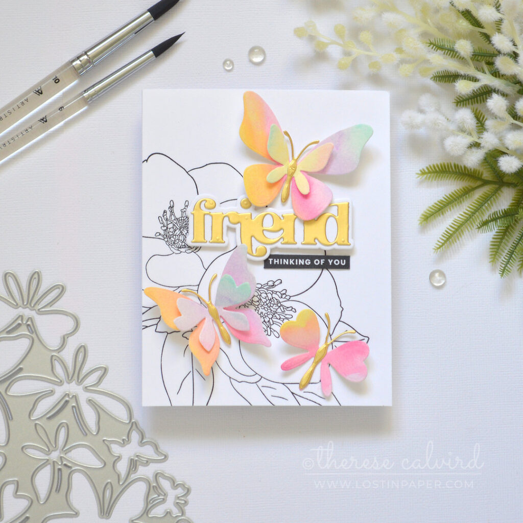 Black and white floral background with layered rainbow die cut butterflies and a gold sentiment Therese Calvird