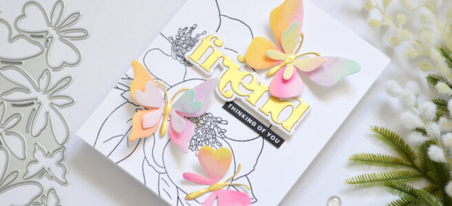 Black and white floral background with layered rainbow die cut butterflies and a gold sentiment Therese Calvird