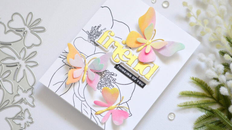 Black and white floral background with layered rainbow die cut butterflies and a gold sentiment Therese Calvird