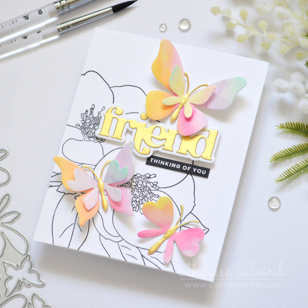Black and white floral background with layered rainbow die cut butterflies and a gold sentiment Therese Calvird