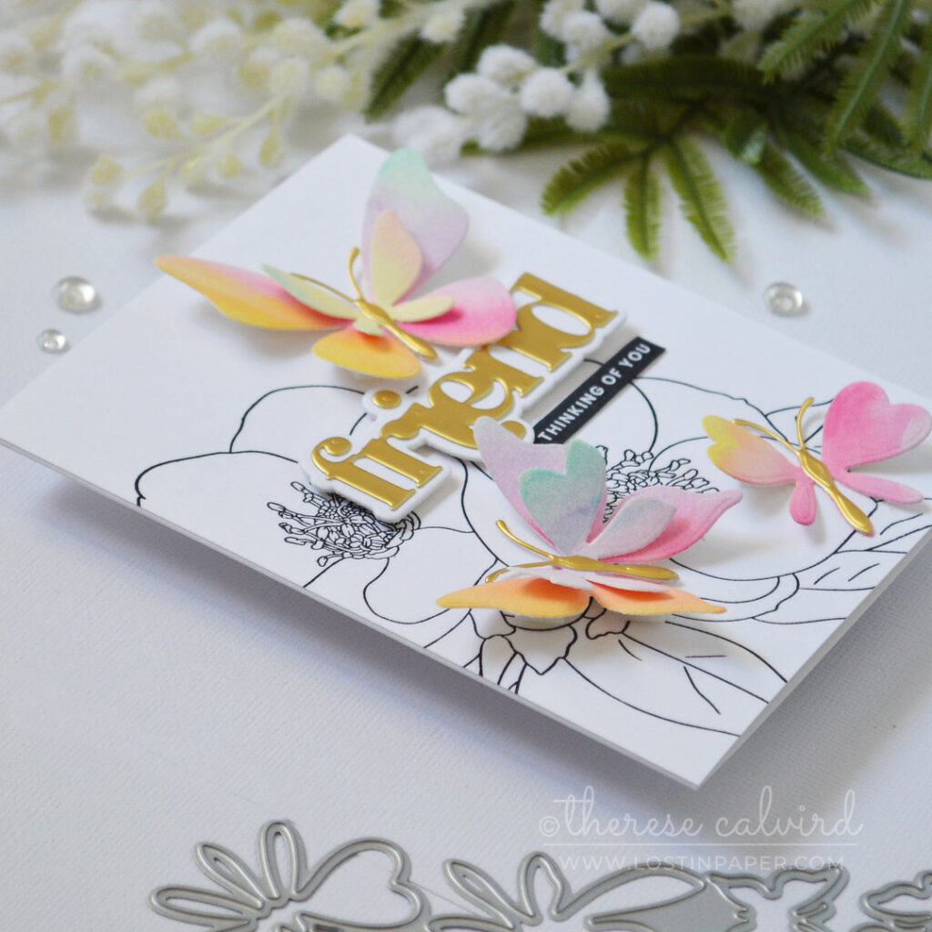 Black and white floral background with layered rainbow die cut butterflies and a gold sentiment Therese Calvird