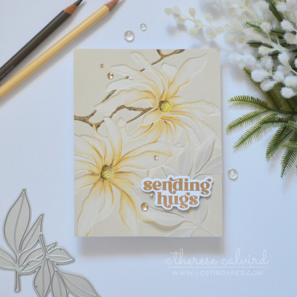 Magnolia Ballerina embossed floral card on sand colored cardstock using Prismacolor pencils on the debossed side with gold embossed sentiment and vellum leaves by Therese Calvird