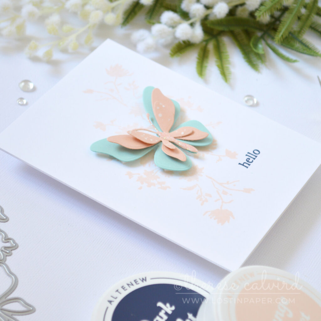 Clean and simple butterfly card with single die cut butterfly and pastel florals by Therese Calvird