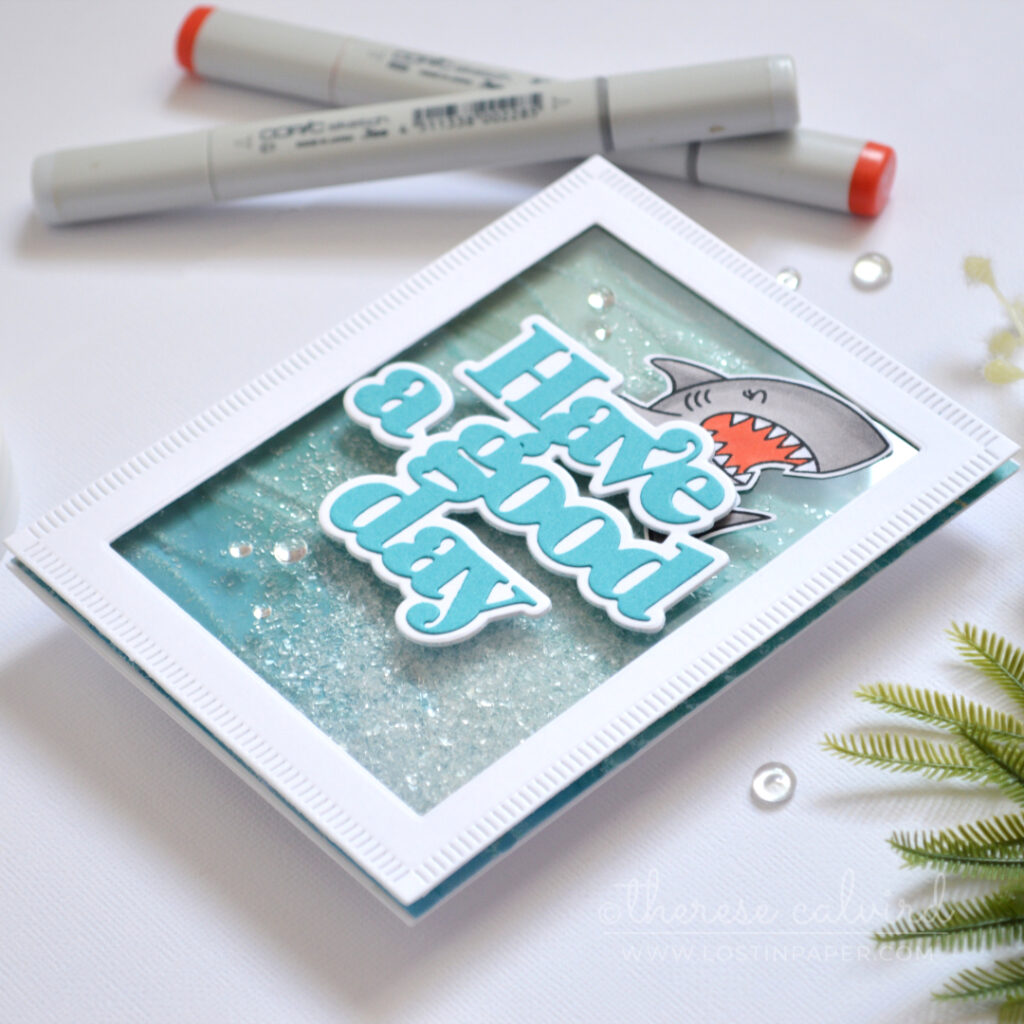 Ocean inspired shaker card with embossed design paper and shark by Therese Calvird