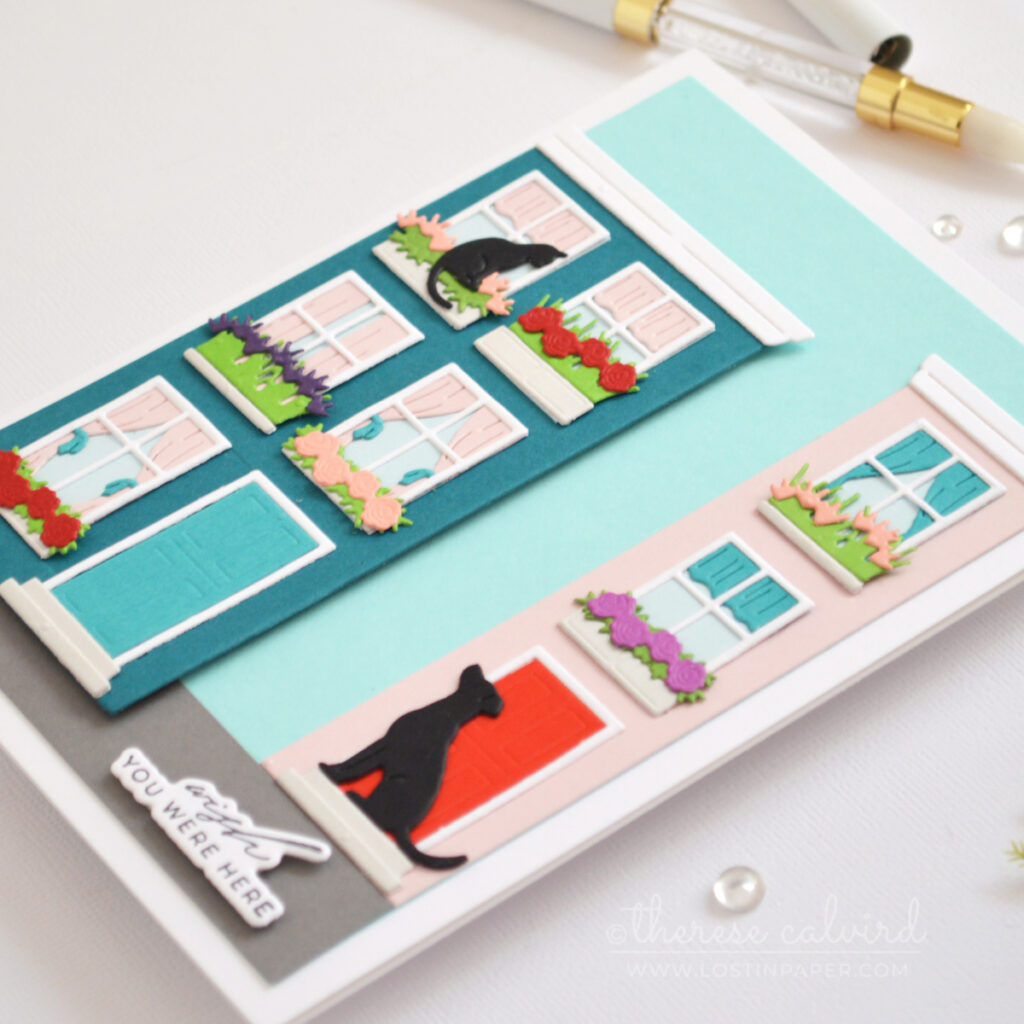 5x7 handmade card featuring dissected Everyday City Holiday die cut houses in dark teal and pale pink with shaped windows, flower boxes, cat and dog details by Therese Calvird