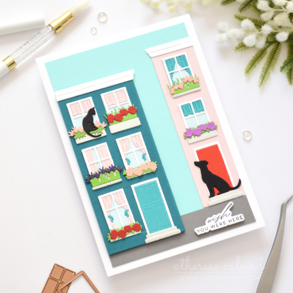 5x7 handmade card featuring dissected Everyday City Holiday die cut houses in dark teal and pale pink with shaped windows, flower boxes, cat and dog details by Therese Calvird