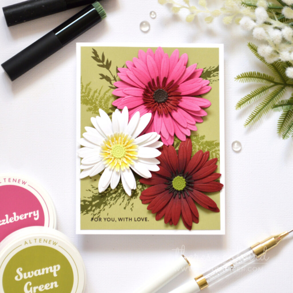 Bright gerbera floral card made with altered layering dies and a tone-on-tone leafy stamped background.