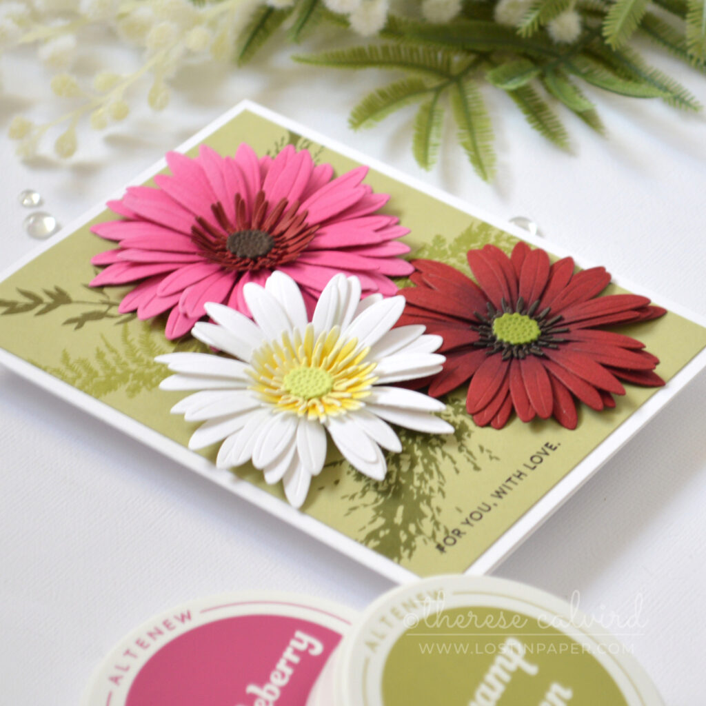 Bright gerbera floral card made with altered layering dies and a tone-on-tone leafy stamped background.