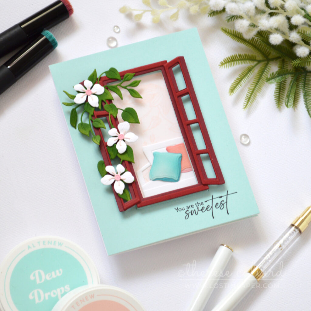 Handmade trifold card with a red acetate window, floral vine, soft wallpaper background, and a seat created from altered window frame dies.