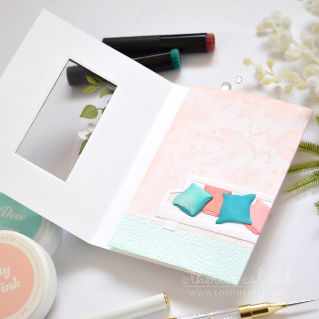 Handmade trifold card with a red acetate window, floral vine, soft wallpaper background, and a seat created from altered window frame dies.