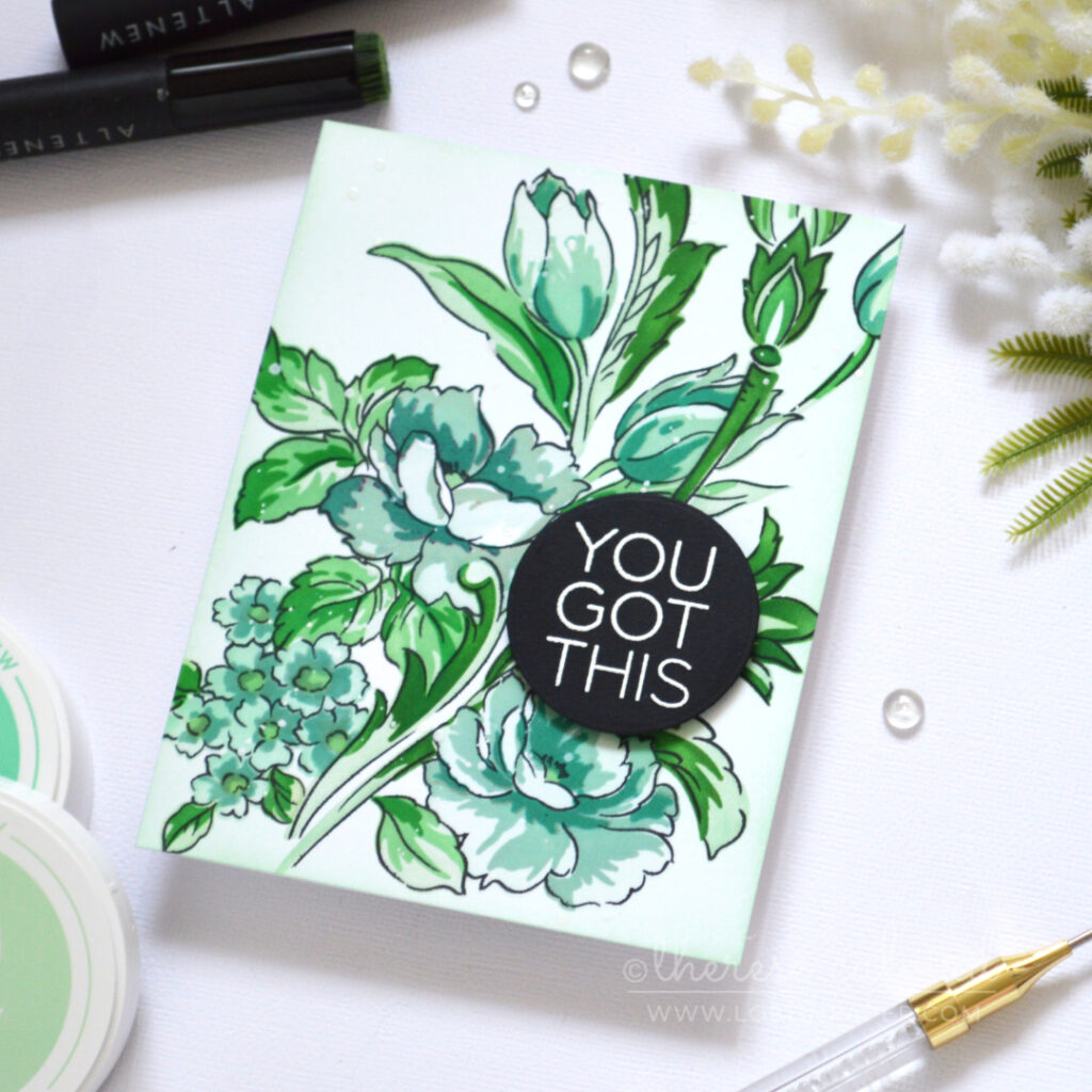 Floral card in cool mint, teal and blue-green tones with a white embossed sentiment on a black circle.