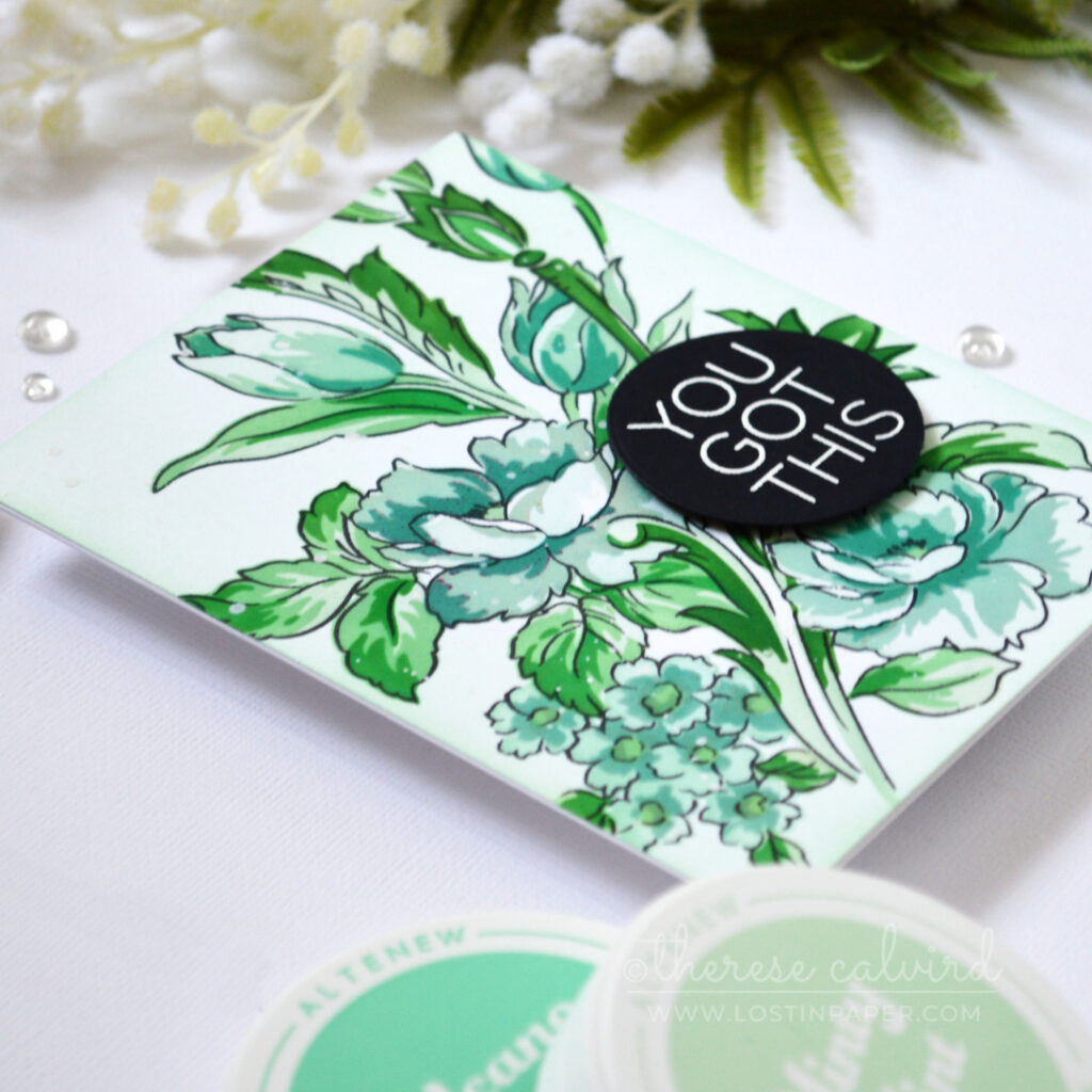 Floral card in cool mint, teal and blue-green tones with a white embossed sentiment on a black circle.
