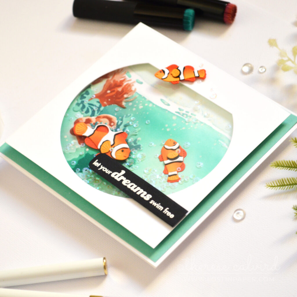 Fishbowl shaker card by Therese Calvird with anemone fish and underwater coral scene
