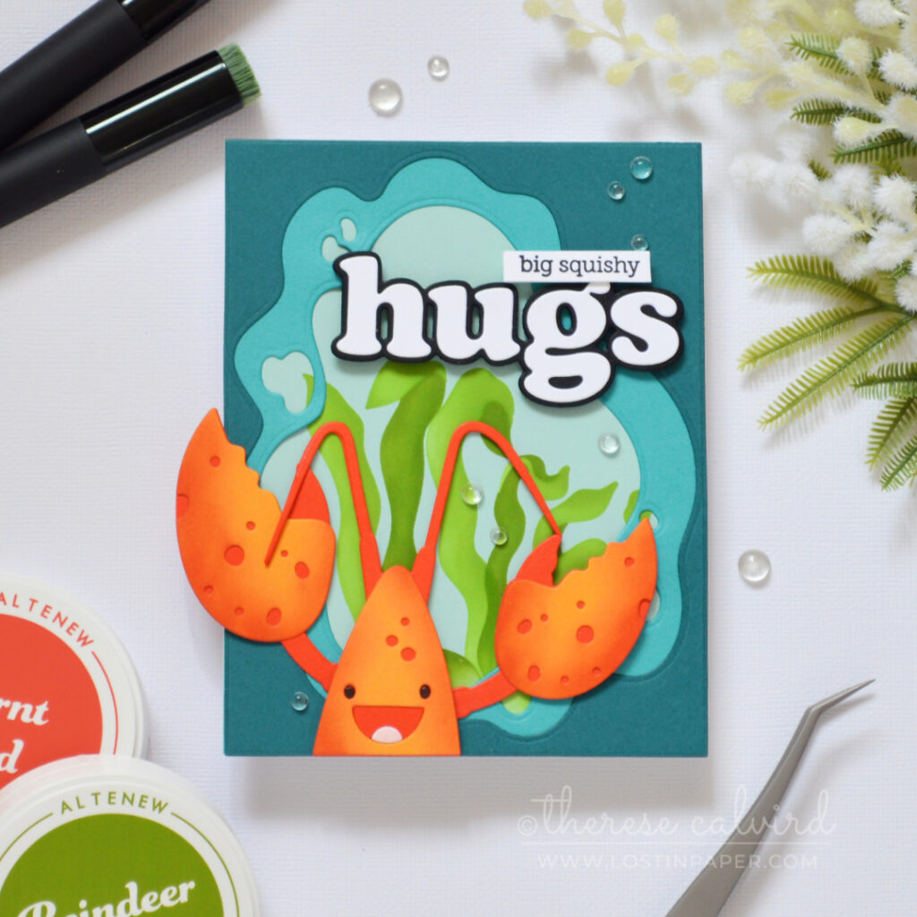 Handmade lobster hugs card with an ocean window frame, seaweed background, and large die cut sentiment.