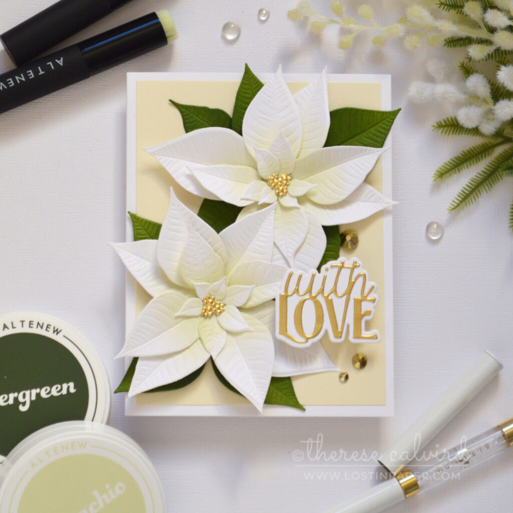 Handmade card with layered white die-cut poinsettias, soft pistachio green ink blending, golden accents, and a layered die-cut sentiment.