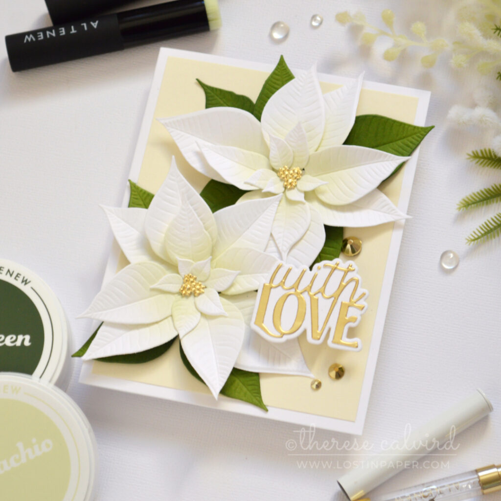 Handmade card with layered white die-cut poinsettias, soft pistachio green ink blending, golden accents, and a layered die-cut sentiment.