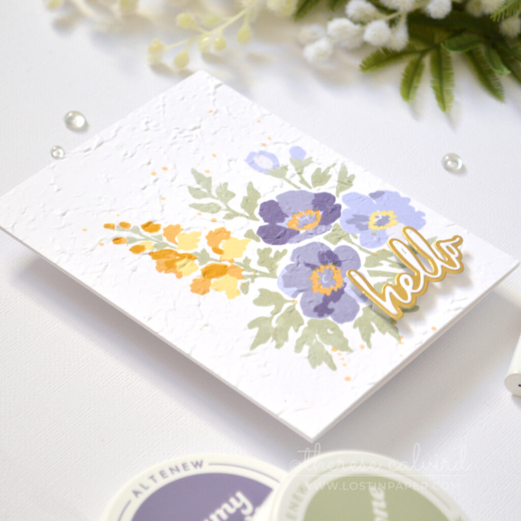 Handmade stamped floral bouquet card with embossed texture and a layered hello sentiment.