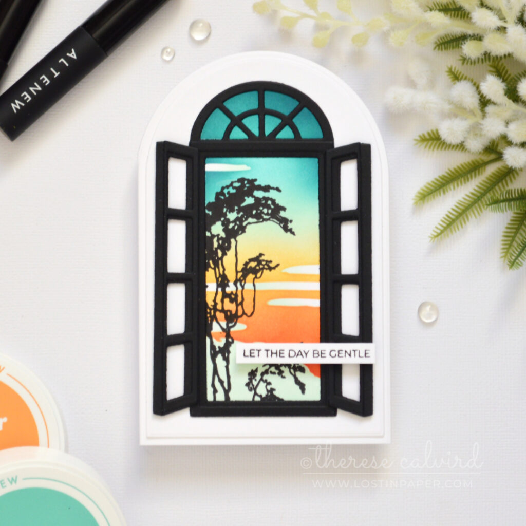 Side-fold arched shaped card with a retro sunset ink blended background and black window frame with shutters.