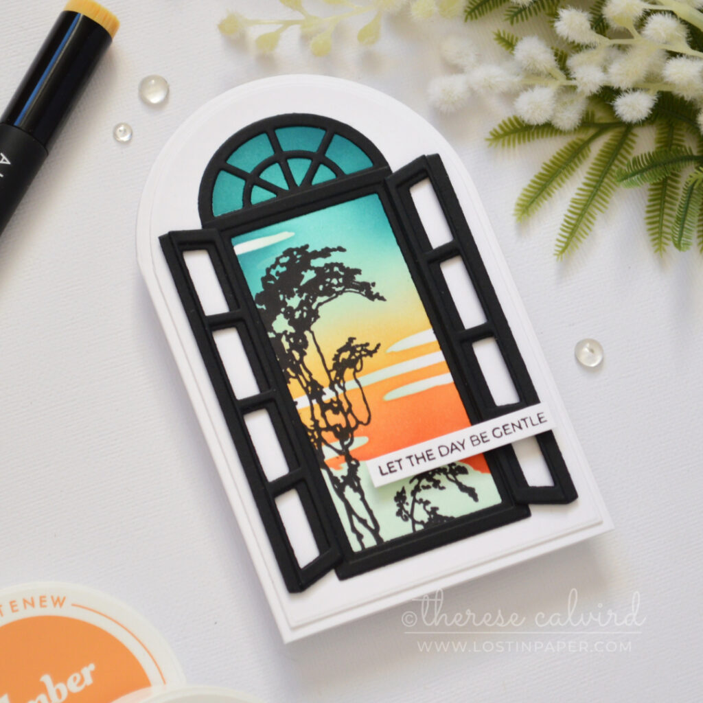 Side-fold arched shaped card with a retro sunset ink blended background and black window frame with shutters.