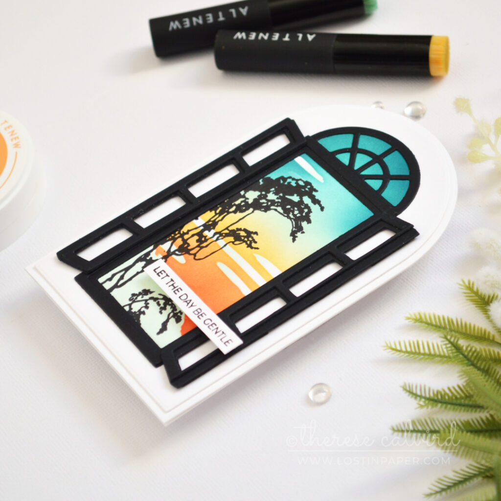 Side-fold arched shaped card with a retro sunset ink blended background and black window frame with shutters.