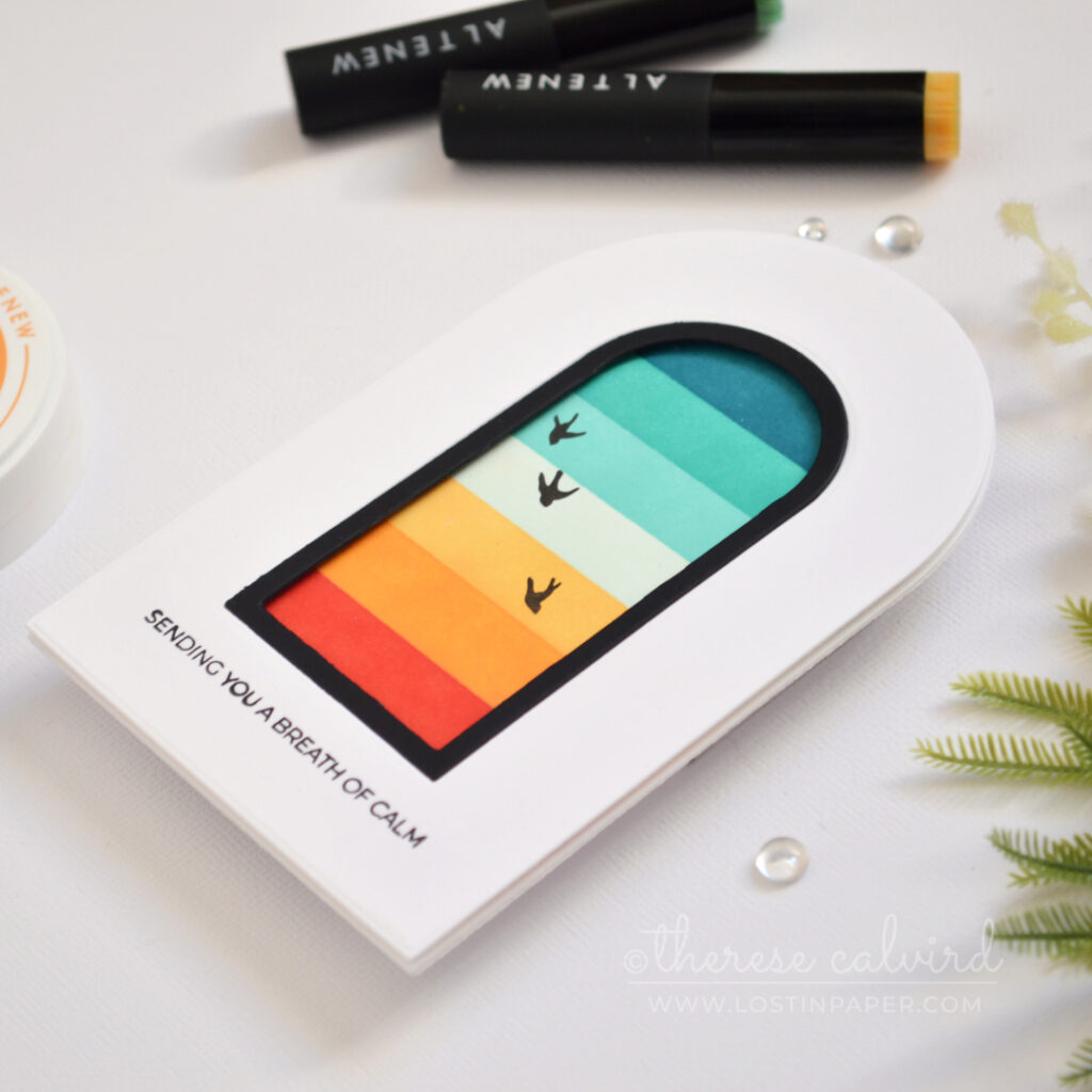 Top-fold arched shaped card with a masked retro rainbow window scene, black frame, and silhouette birds.