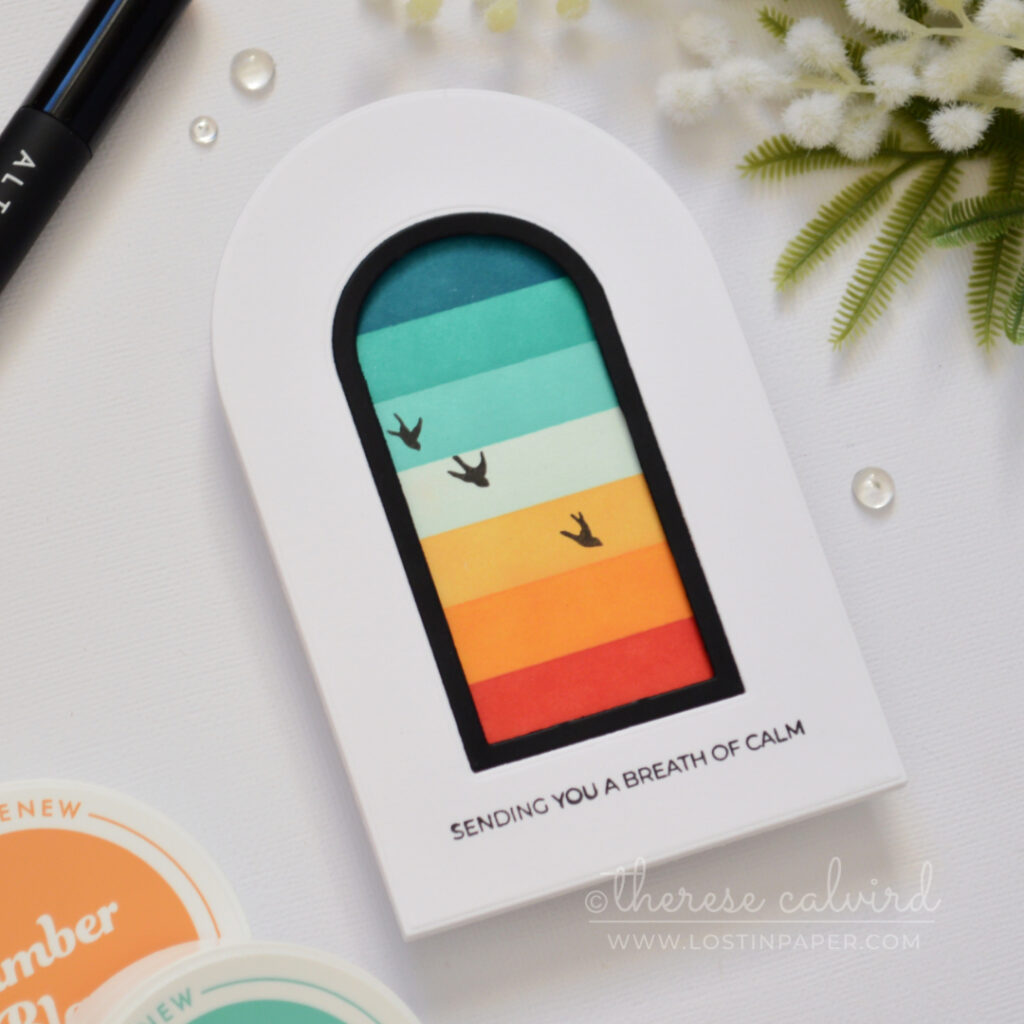 Top-fold arched shaped card with a masked retro rainbow window scene, black frame, and silhouette birds.