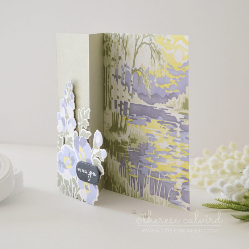 Sage green and purple floral trifold card with an embossed front, circle window, bold sentiment and soft stenciled landscape scene.