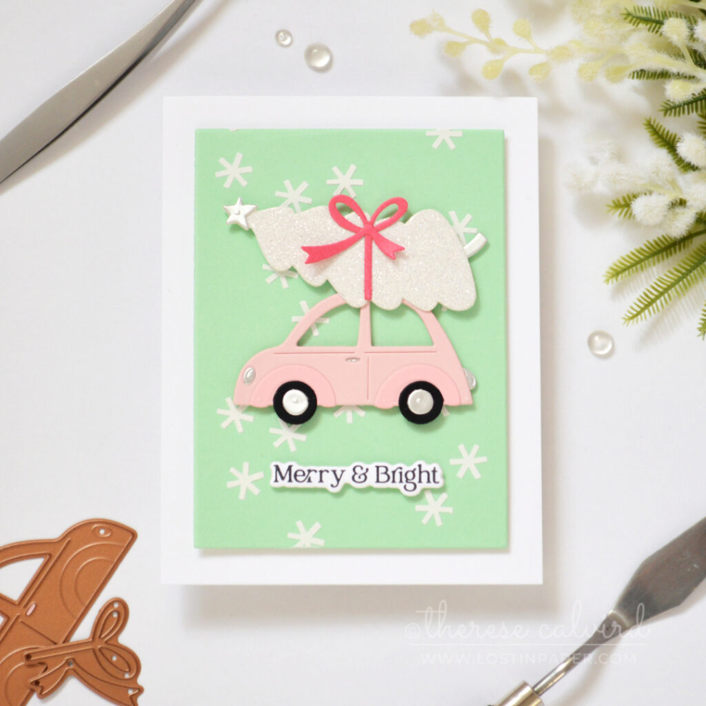 Mint Christmas card with white snowflake texture, pale pink car and glittery white tree.