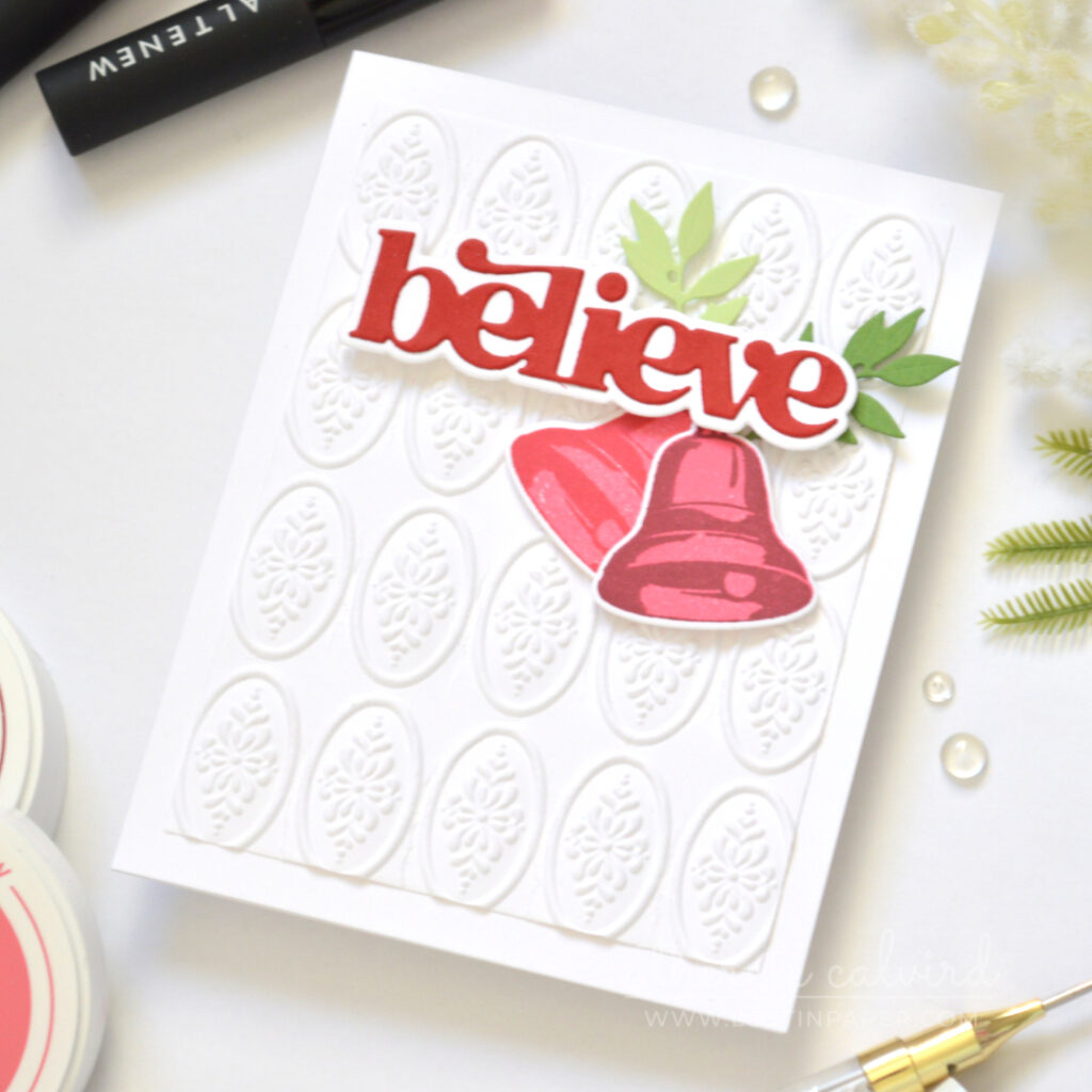 Christmas card with a dimensional embossed background and poinsettia focal image.